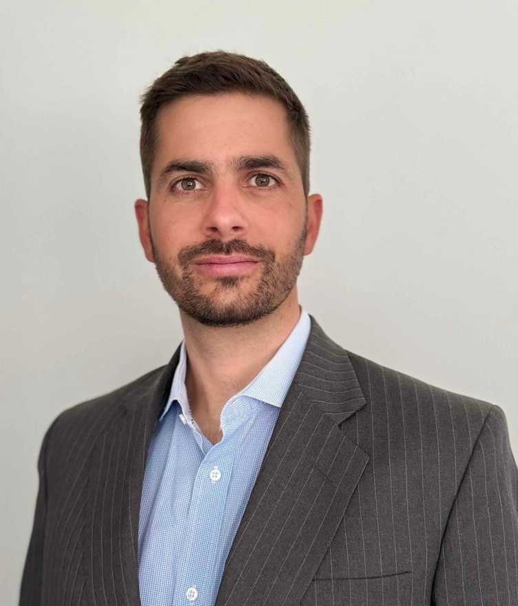 Enlarged view: Photo portrait of Loic Pellissier wearing a blue shirt and a grey coat